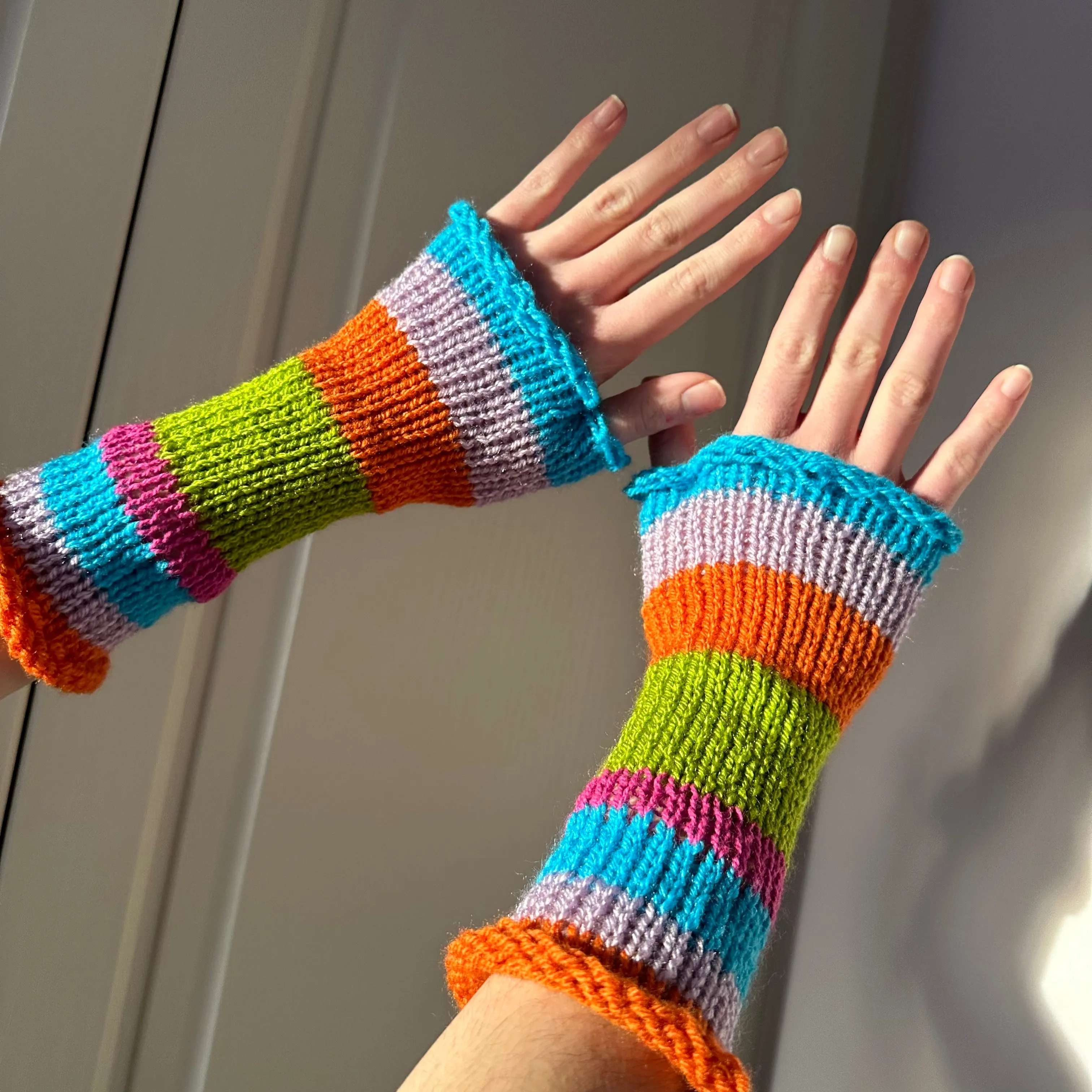 Handmade knitted rainbow striped hand warmers